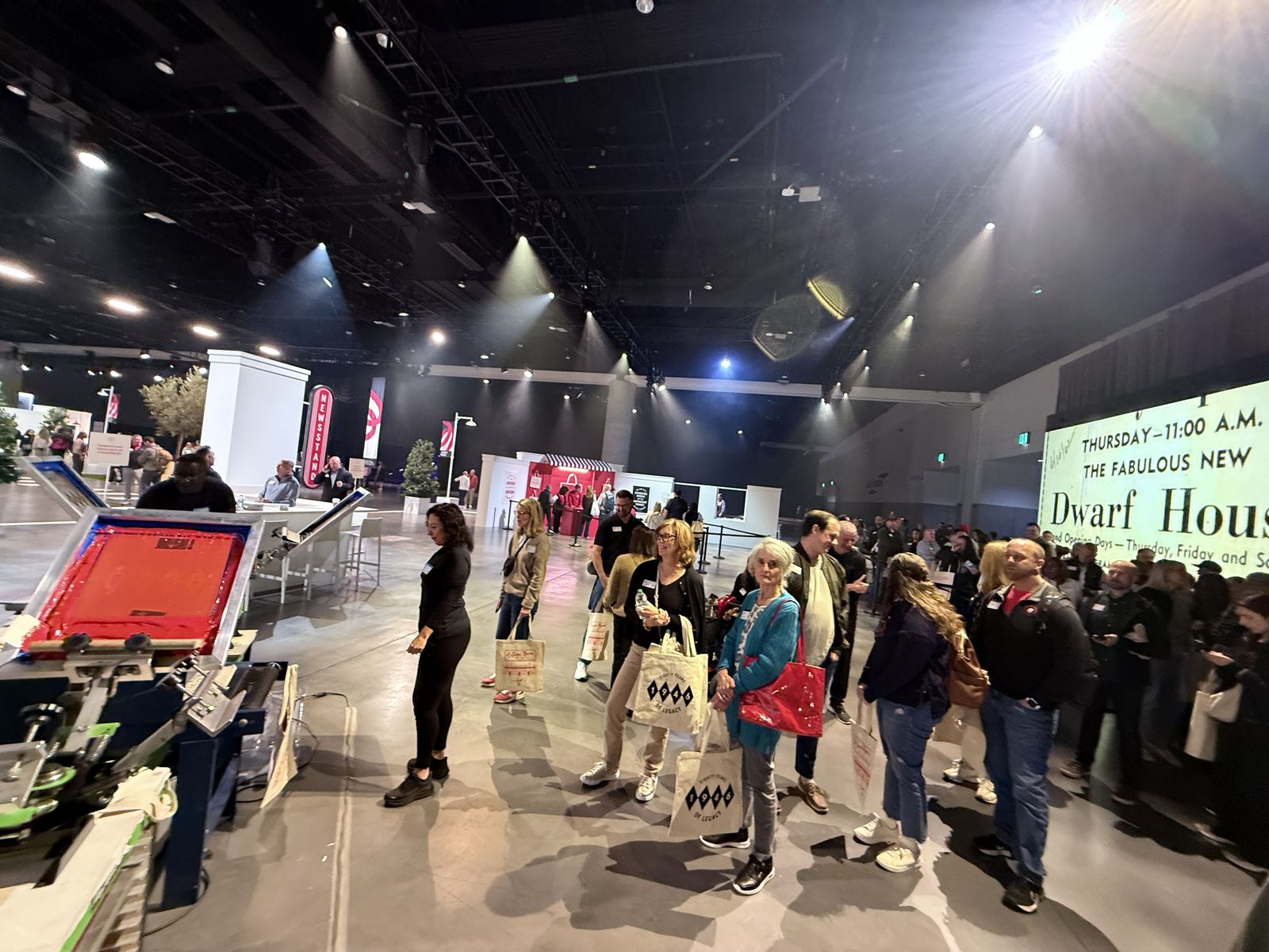 Busy convention floor crowd surrounding a live personalization station