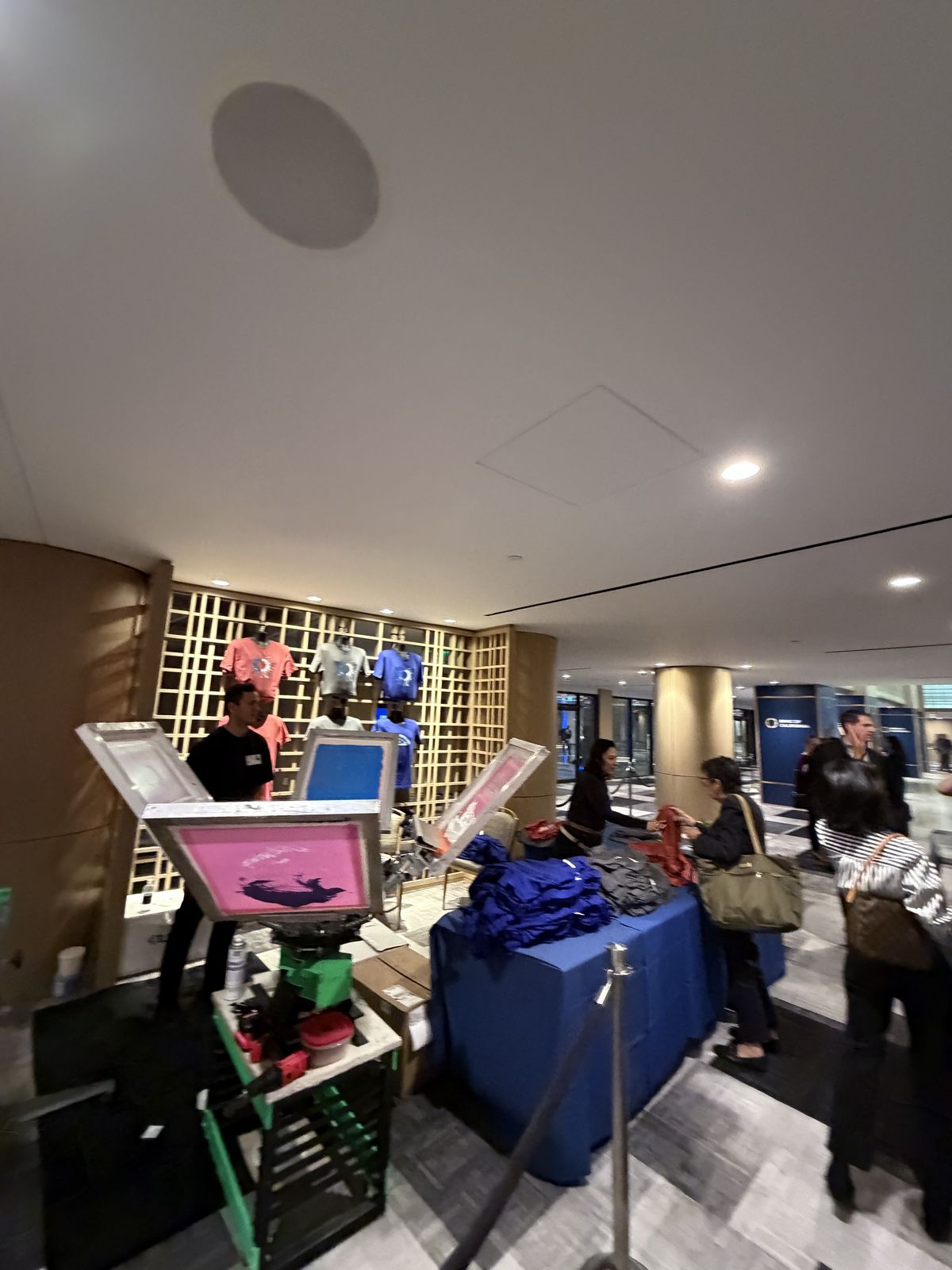 Personalization station with attendant set up in a hotel corridor with stanchions